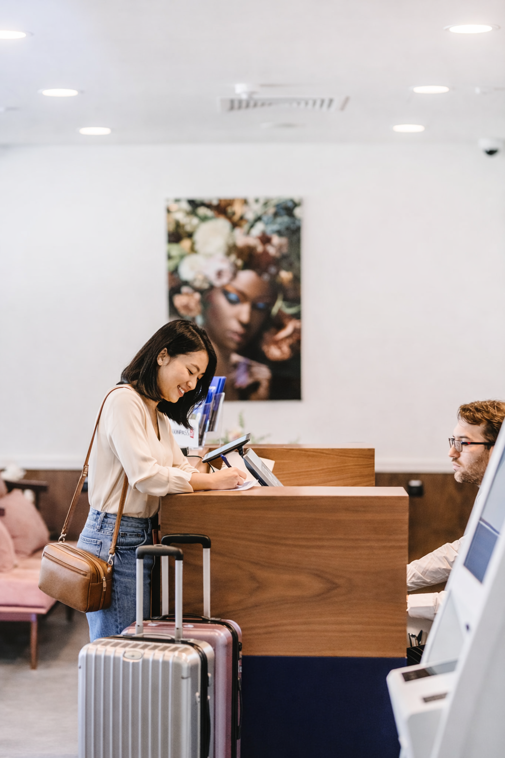 Traveler checking in at Kepler airport hotel reception desk for transit stay and sleep lounge access